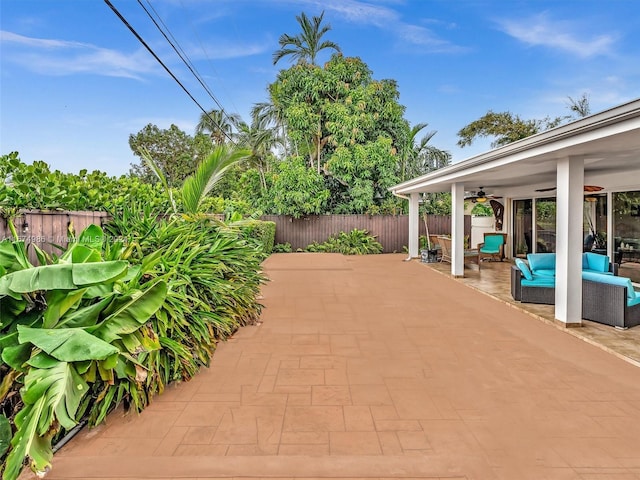 view of patio / terrace with ceiling fan and an outdoor living space