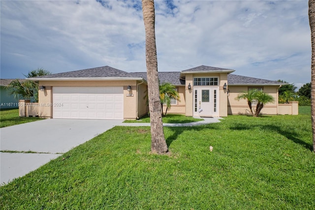 13592 Clara Ln, Port Charlotte, FL 33981 - view of front of house featuring a garage, stucco siding, driveway, and a front yard