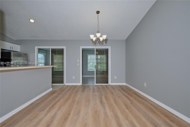 interior space featuring a chandelier, light hardwood / wood-style flooring, and plenty of natural light