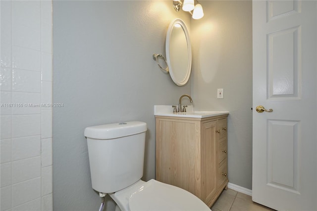 bathroom with tile patterned flooring, vanity, and toilet