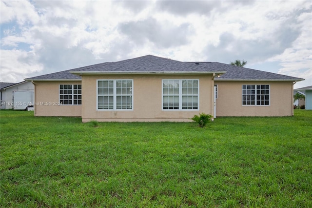 13592 Clara Ln, Port Charlotte, FL 33981 - rear view of house featuring stucco siding and a yard