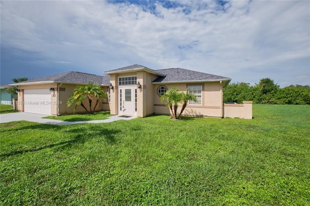 view of front facade featuring a front yard and a garage