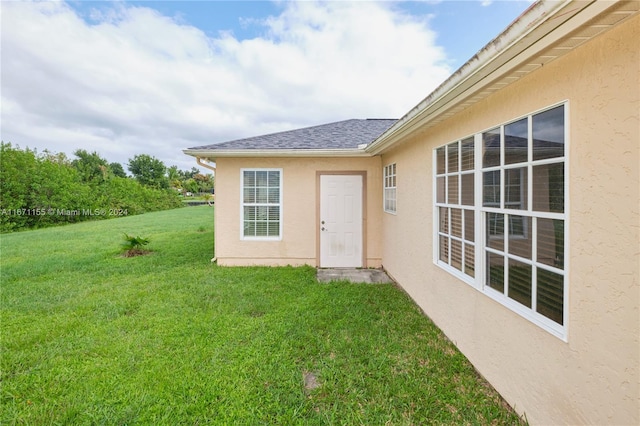 property entrance with a yard