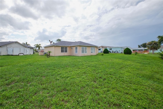 13592 Clara Ln, Port Charlotte, FL 33981 - back of property with stucco siding and a lawn