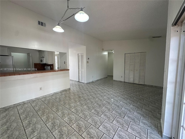 unfurnished living room with a textured ceiling