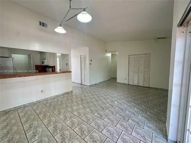 unfurnished living room featuring a textured ceiling