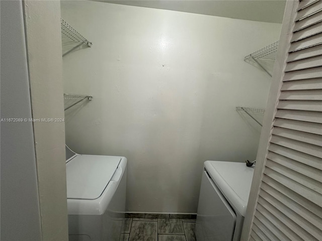 clothes washing area featuring independent washer and dryer