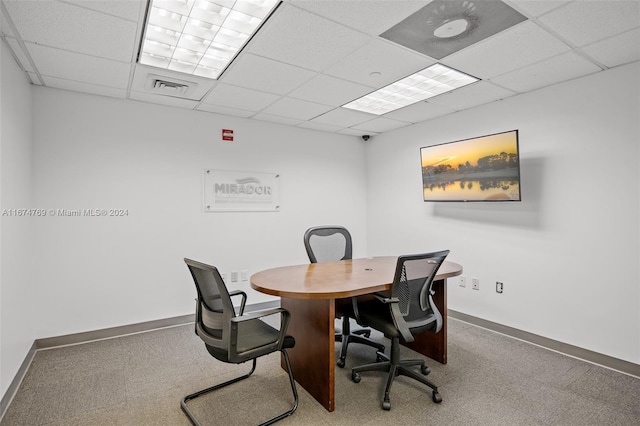 home office with a paneled ceiling, carpet floors, and visible vents