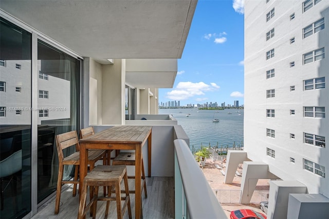 balcony featuring a city view and a water view