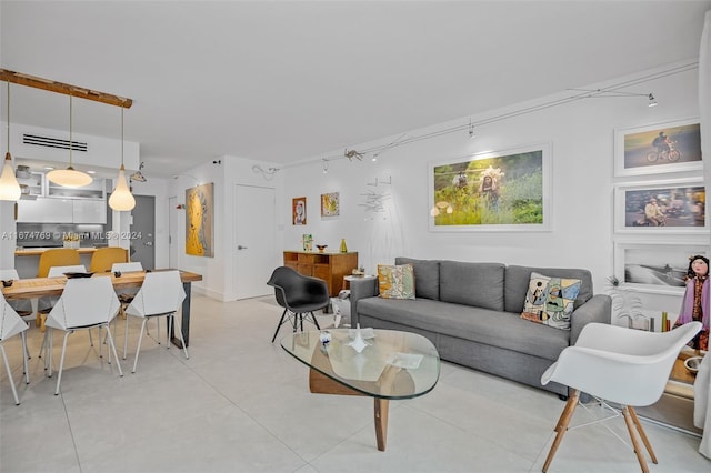 living area with visible vents and light tile patterned floors
