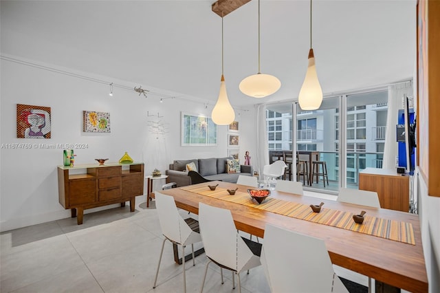 dining room featuring rail lighting and light tile patterned floors