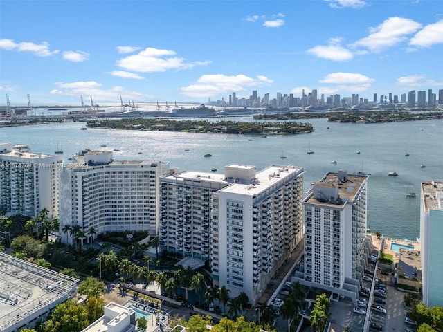 drone / aerial view with a city view and a water view