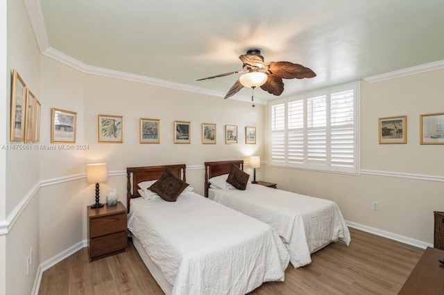 bedroom featuring crown molding, hardwood / wood-style flooring, and ceiling fan