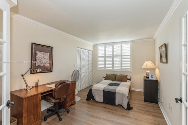 bedroom with ornamental molding and light wood-type flooring