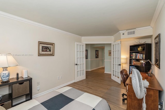 bedroom with french doors, wood-type flooring, and ornamental molding