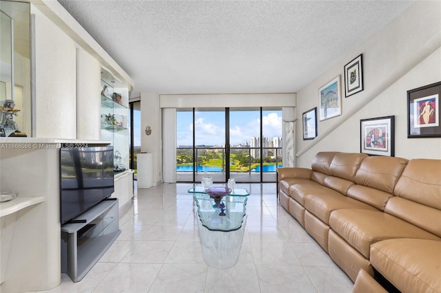 living room featuring expansive windows and a textured ceiling