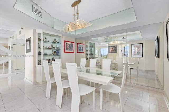 dining space featuring an inviting chandelier and light tile patterned floors