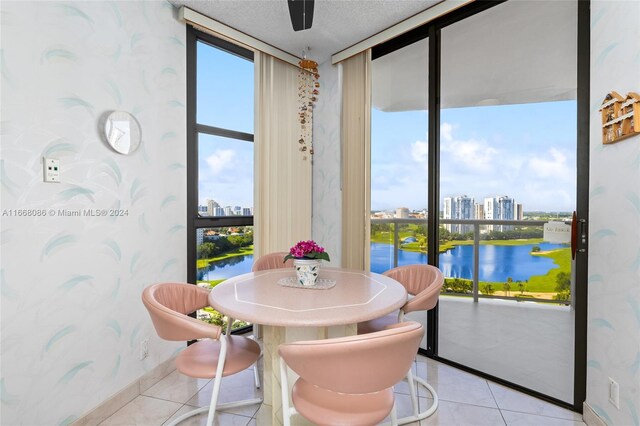 20281 E Country Club Dr Unit 1709, Aventura, FL 33180 - tiled dining area with wallpapered walls, a water view, a wall of windows, a city view, and baseboards