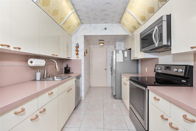 20281 E Country Club Dr Unit 1709, Aventura, FL 33180 - kitchen with appliances with stainless steel finishes, a sink, light countertops, and white cabinetry