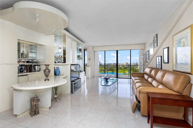 living room with a wall of windows and a textured ceiling