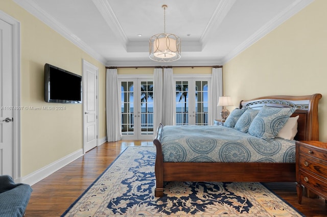 bedroom with access to outside, french doors, a raised ceiling, hardwood / wood-style floors, and crown molding