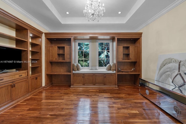 unfurnished office featuring an inviting chandelier, ornamental molding, dark hardwood / wood-style floors, and a tray ceiling