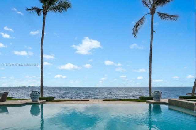 view of swimming pool with a water view