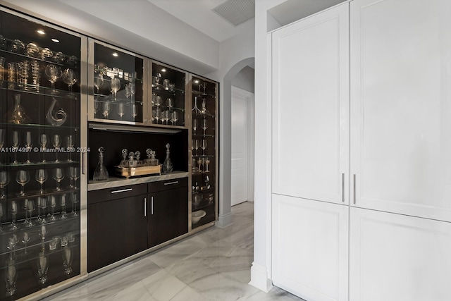 33 Arvida Pkwy, Coral Gables, FL 33156 - indoor dry bar with arched walkways and light marble finish floors