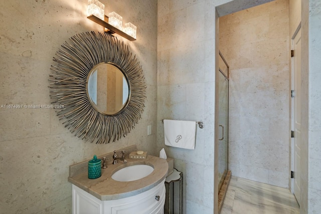 bathroom featuring vanity and a shower with shower door