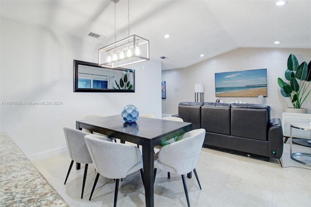 dining area featuring light tile patterned floors and lofted ceiling