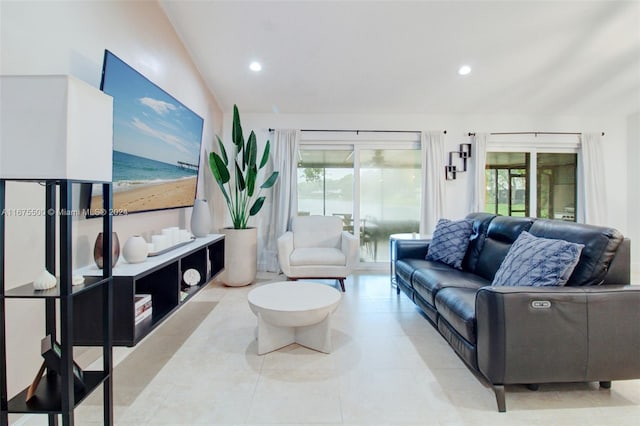 living room featuring lofted ceiling and light tile patterned flooring