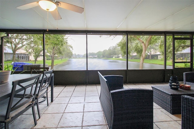 sunroom / solarium with a water view and ceiling fan