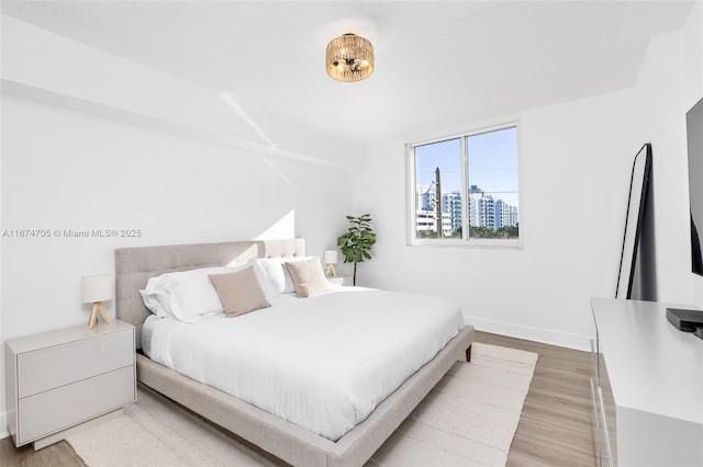 bedroom with hardwood / wood-style flooring