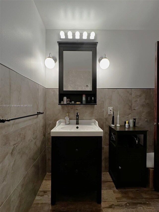 interior details featuring backsplash, sink, and dark stone counters