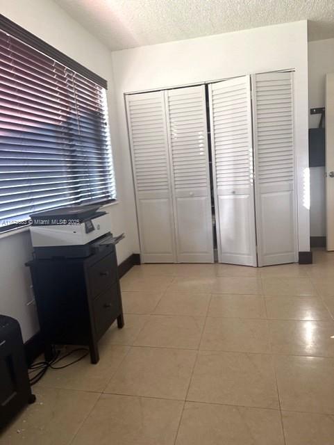 spacious closet featuring light tile patterned flooring