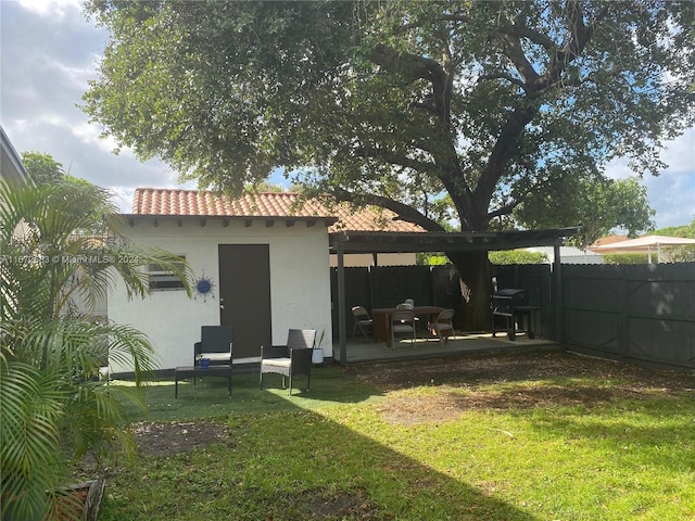 back of house with a lawn and a patio area