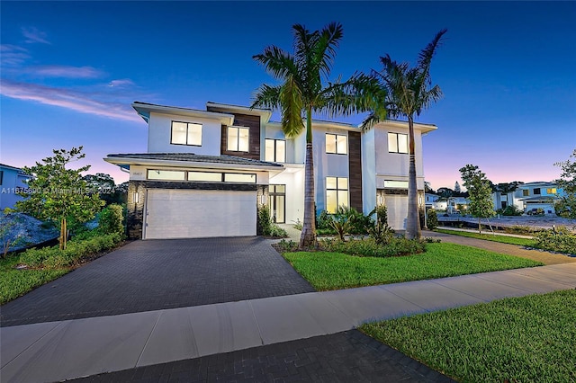 view of front of property with a yard and a garage