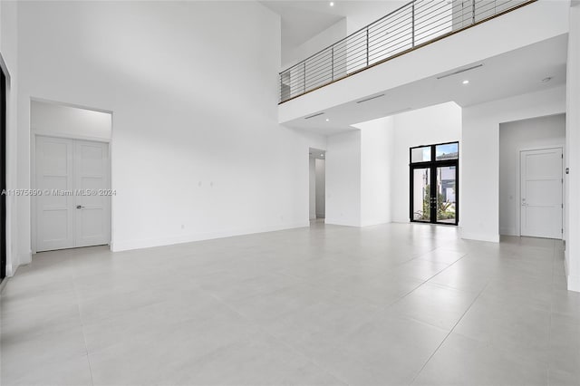 empty room featuring a towering ceiling