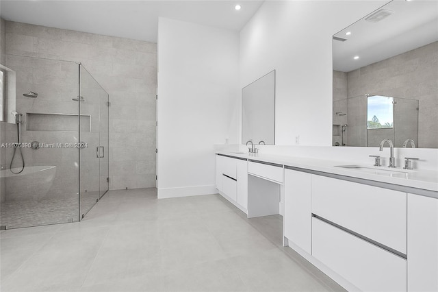 bathroom with vanity and a shower with shower door