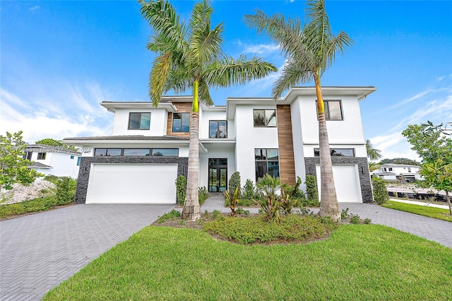 view of front of property with a front yard and a garage