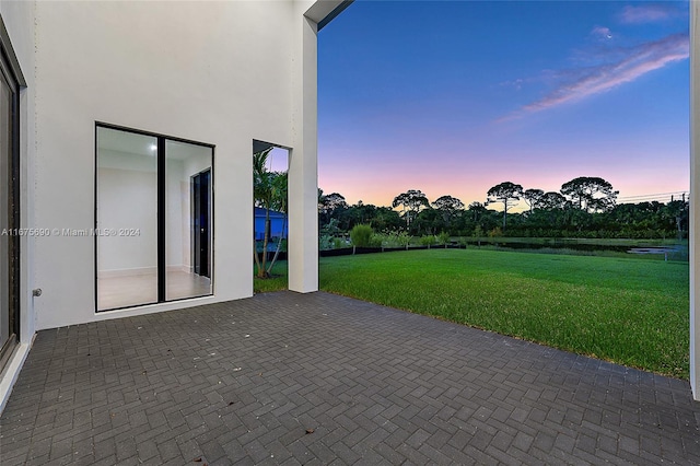 patio terrace at dusk with a lawn