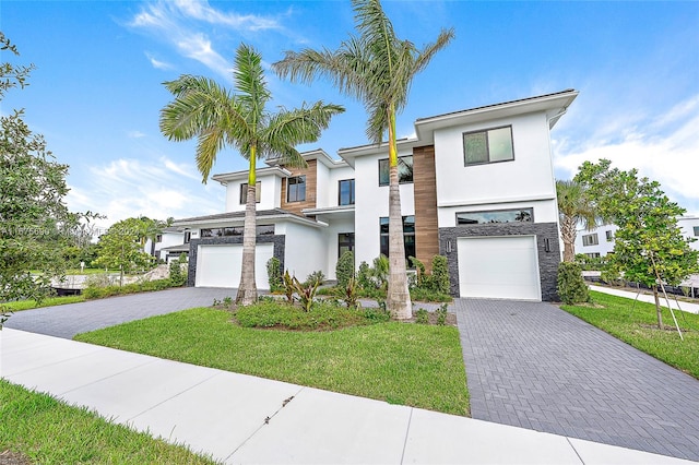 contemporary home featuring a front yard and a garage