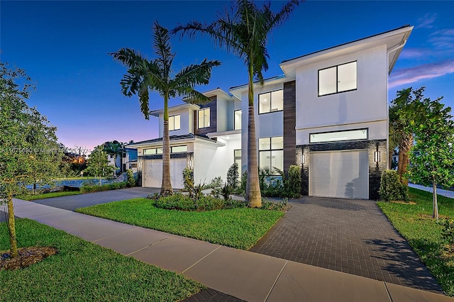 modern home featuring a yard and a garage