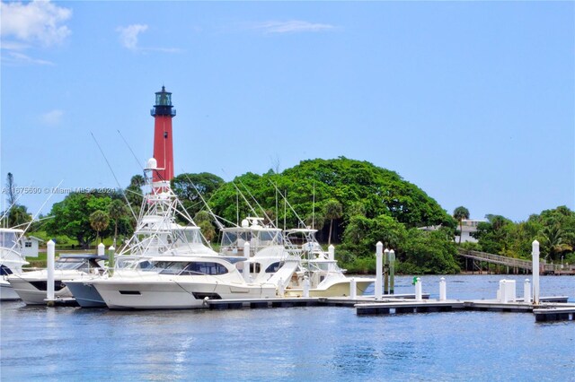 surrounding community with a dock and a water view