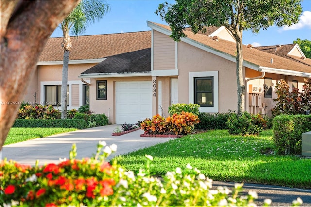 view of front of home with a front lawn and a garage