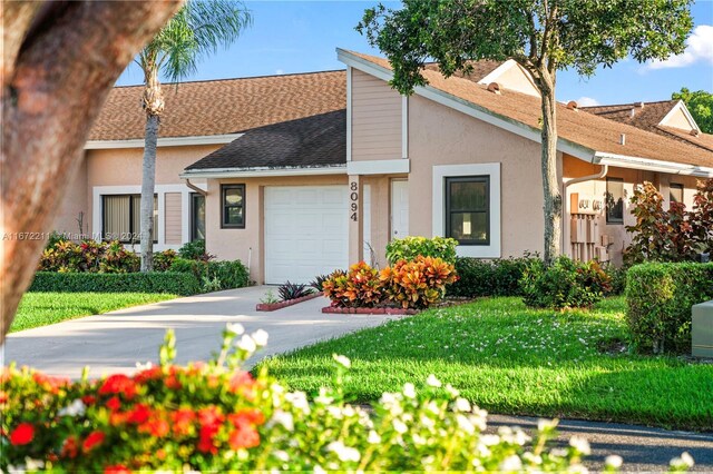 8094 Songbird Ter Unit 8094, Boca Raton, FL 33496 - view of front facade featuring a garage, stucco siding, driveway, and a shingled roof