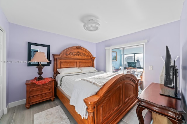 bedroom featuring light hardwood / wood-style floors and access to exterior