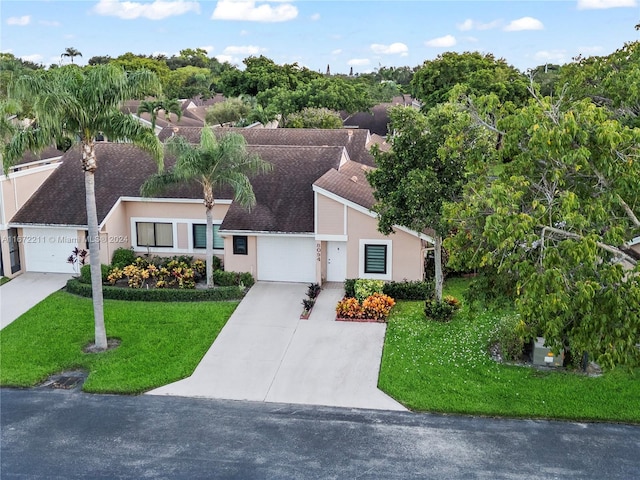 ranch-style home with a garage and a front yard