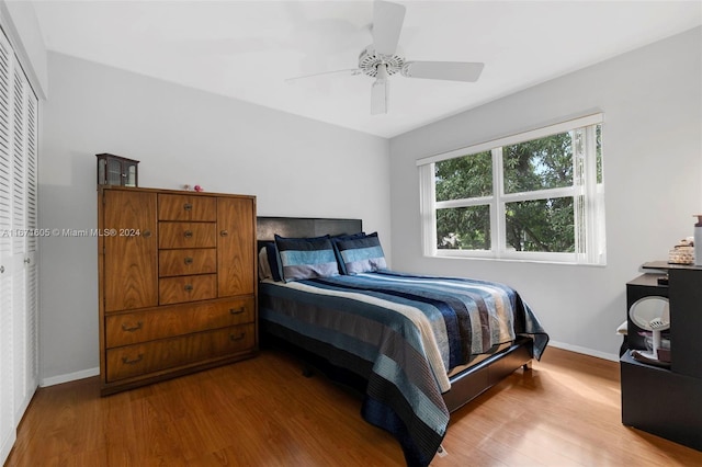 bedroom featuring wood-type flooring, a closet, and ceiling fan