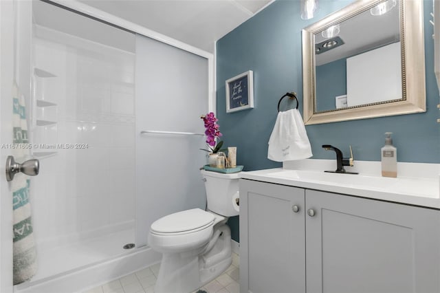 bathroom with tile patterned floors, toilet, walk in shower, and vanity